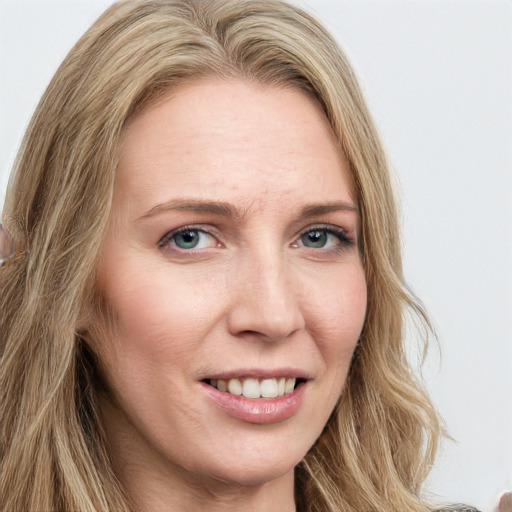 Joyful white young-adult female with long  brown hair and blue eyes