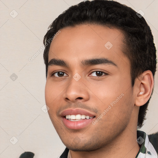 Joyful white young-adult male with short  black hair and brown eyes