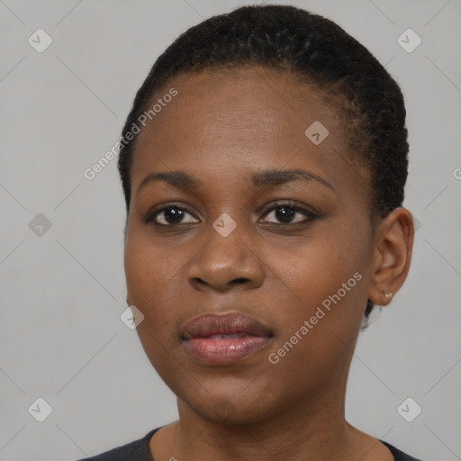 Joyful black young-adult female with short  black hair and brown eyes