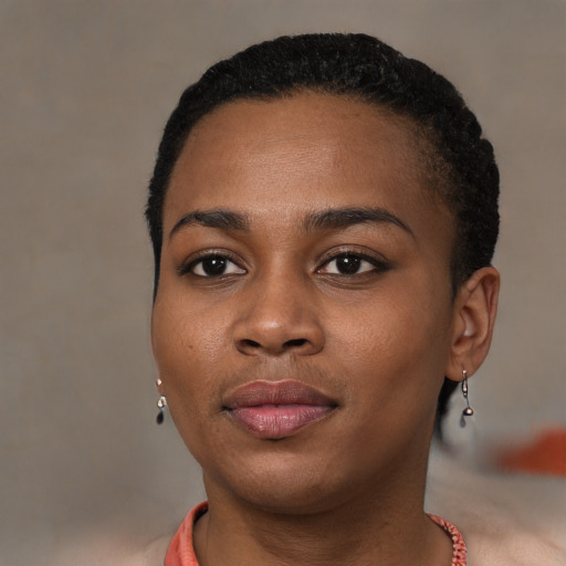 Joyful black young-adult female with short  brown hair and brown eyes
