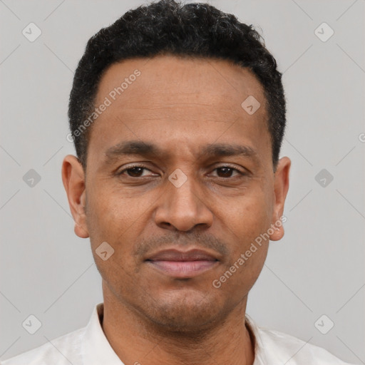 Joyful latino adult male with short  black hair and brown eyes