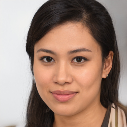 Joyful latino young-adult female with long  brown hair and brown eyes