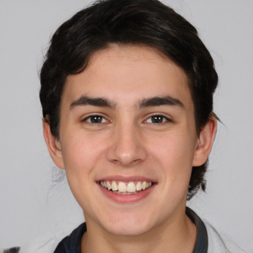 Joyful white young-adult male with medium  brown hair and brown eyes