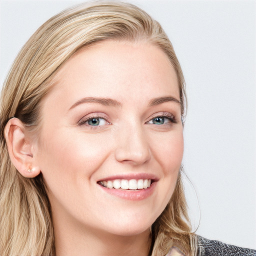 Joyful white young-adult female with long  brown hair and blue eyes