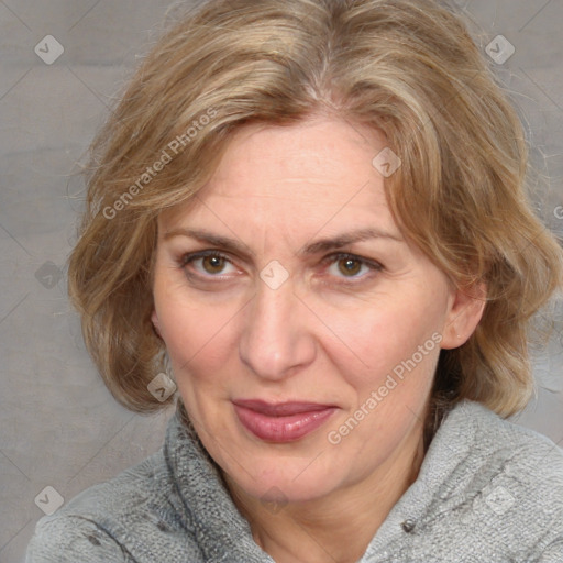 Joyful white adult female with medium  brown hair and blue eyes