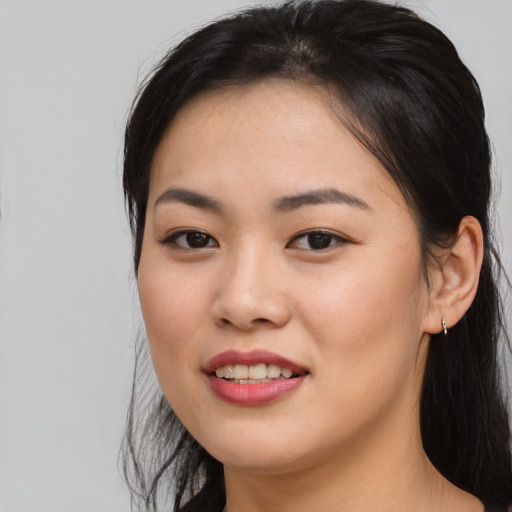 Joyful asian young-adult female with long  black hair and brown eyes