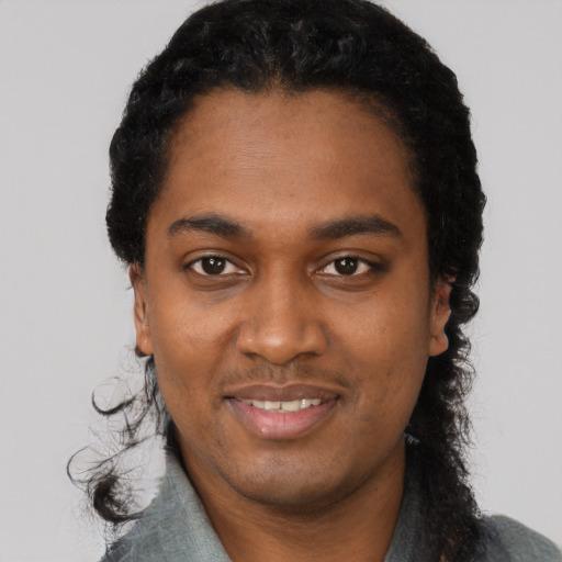 Joyful black young-adult male with short  black hair and brown eyes