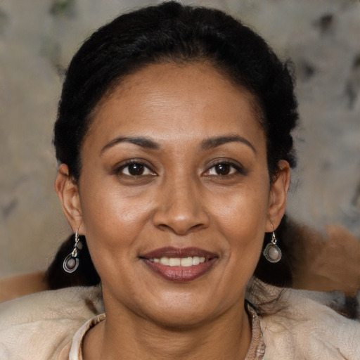 Joyful latino adult female with short  brown hair and brown eyes