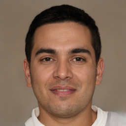 Joyful white young-adult male with short  black hair and brown eyes