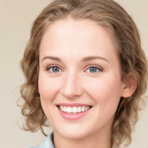 Joyful white young-adult female with medium  brown hair and blue eyes