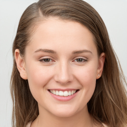 Joyful white young-adult female with long  brown hair and grey eyes