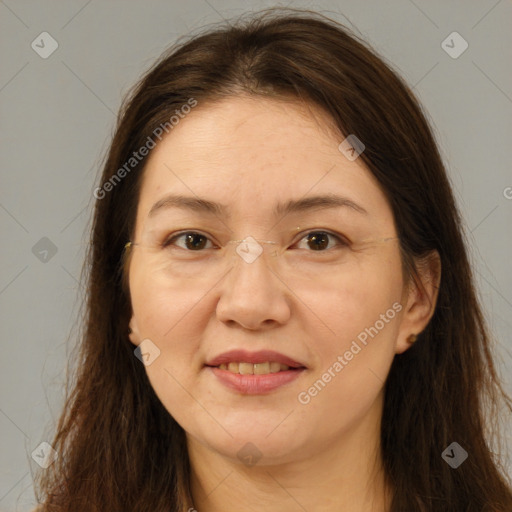 Joyful white adult female with long  brown hair and brown eyes