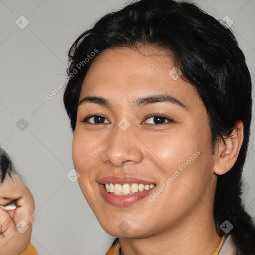 Joyful white young-adult female with medium  black hair and brown eyes