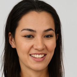 Joyful latino young-adult female with long  brown hair and brown eyes