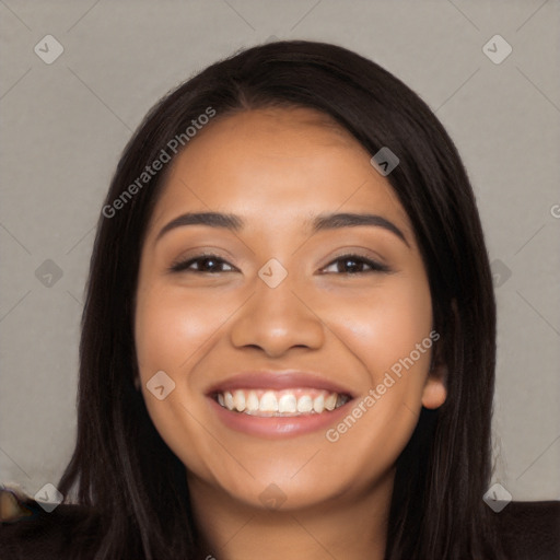 Joyful latino young-adult female with long  black hair and brown eyes