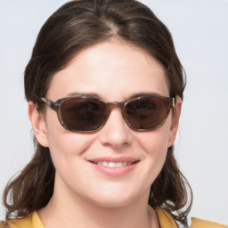 Joyful white young-adult female with medium  brown hair and blue eyes