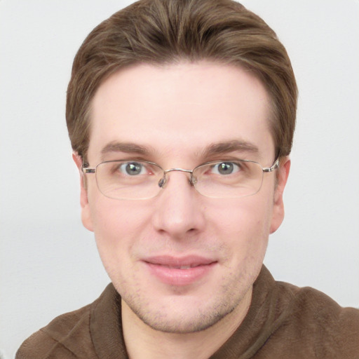 Joyful white adult male with short  brown hair and blue eyes