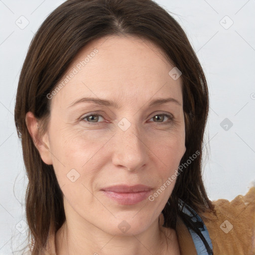 Joyful white adult female with long  brown hair and grey eyes