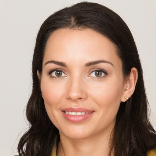 Joyful white young-adult female with long  brown hair and brown eyes