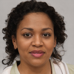 Joyful black adult female with medium  brown hair and brown eyes