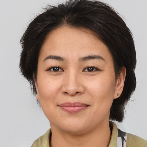 Joyful asian adult female with medium  brown hair and brown eyes