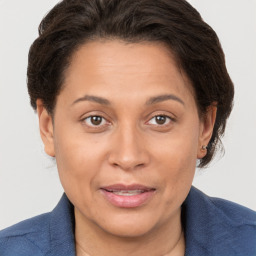 Joyful white adult female with short  brown hair and brown eyes