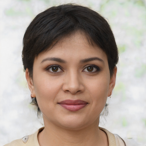 Joyful latino young-adult female with short  brown hair and brown eyes