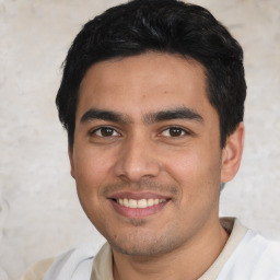Joyful white young-adult male with short  black hair and brown eyes