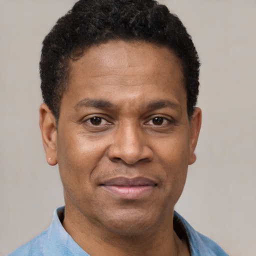 Joyful latino adult male with short  black hair and brown eyes