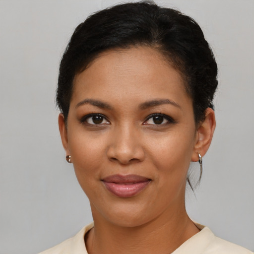 Joyful latino young-adult female with short  brown hair and brown eyes