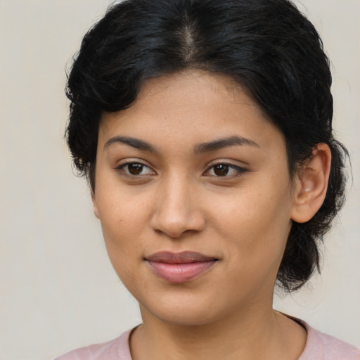 Joyful latino young-adult female with medium  brown hair and brown eyes