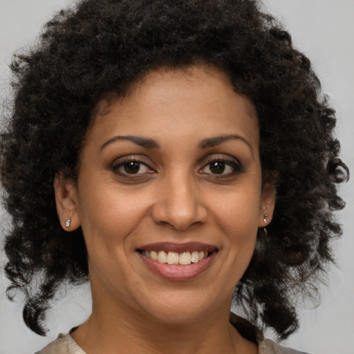 Joyful black young-adult female with medium  brown hair and brown eyes