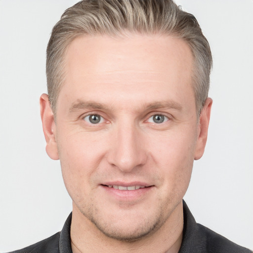 Joyful white adult male with short  brown hair and grey eyes