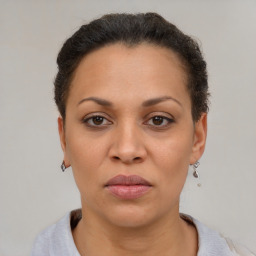 Joyful black adult female with short  brown hair and brown eyes