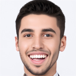 Joyful white young-adult male with short  black hair and brown eyes