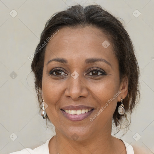 Joyful black adult female with medium  brown hair and brown eyes