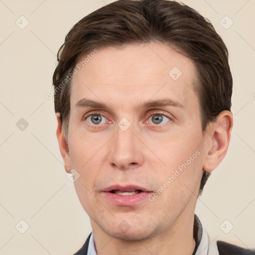 Joyful white adult male with short  brown hair and grey eyes