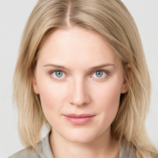 Joyful white young-adult female with medium  brown hair and blue eyes