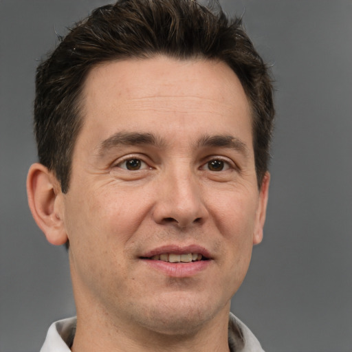 Joyful white adult male with short  brown hair and brown eyes