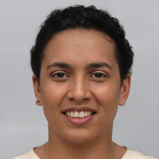 Joyful latino young-adult female with short  brown hair and brown eyes