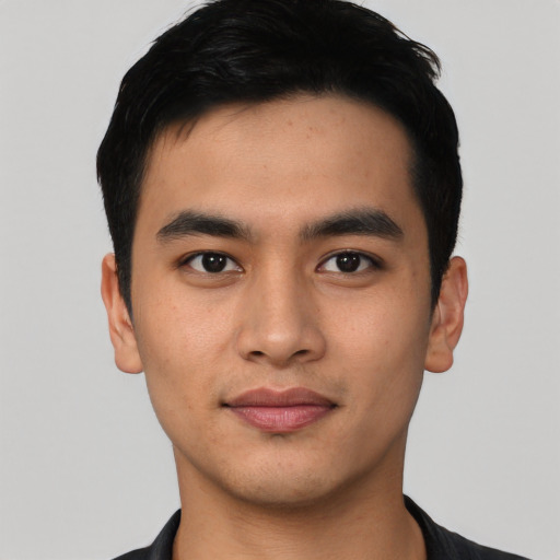 Joyful asian young-adult male with short  black hair and brown eyes