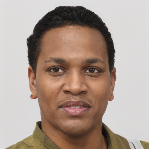 Joyful black young-adult male with short  black hair and brown eyes