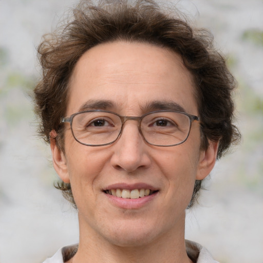 Joyful white adult male with medium  brown hair and brown eyes