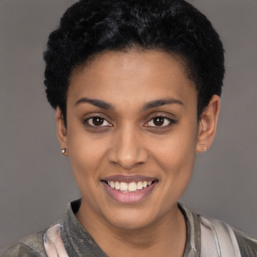 Joyful latino young-adult female with short  black hair and brown eyes
