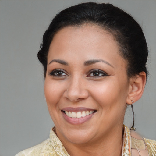 Joyful latino adult female with short  brown hair and brown eyes
