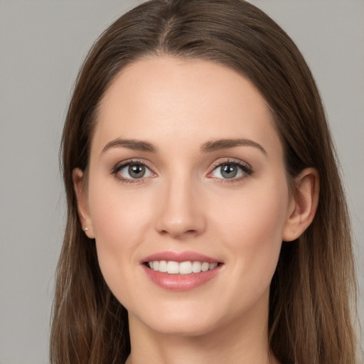 Joyful white young-adult female with long  brown hair and grey eyes