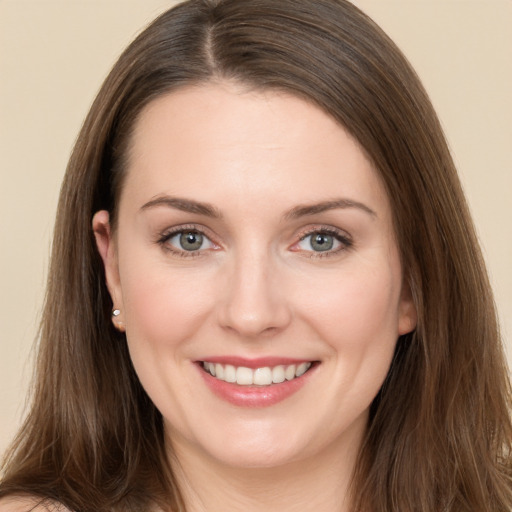 Joyful white young-adult female with long  brown hair and brown eyes