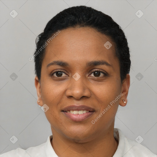 Joyful black young-adult female with short  black hair and brown eyes