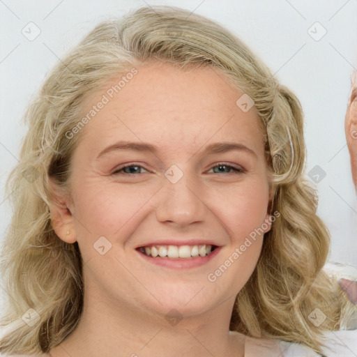 Joyful white young-adult female with long  brown hair and blue eyes