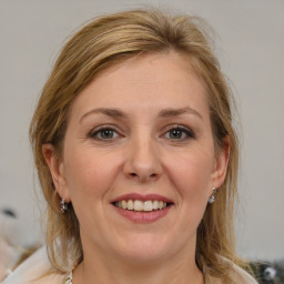 Joyful white adult female with medium  brown hair and grey eyes